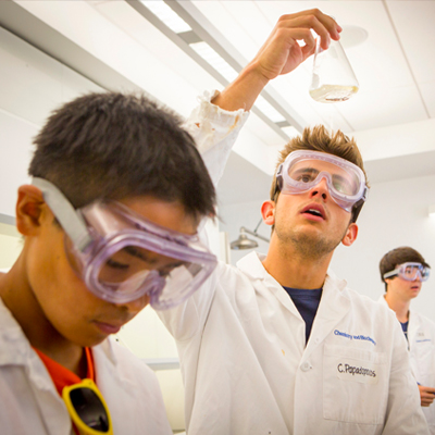 Students in science lab with beaker