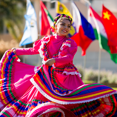 Dancer in front of international flags