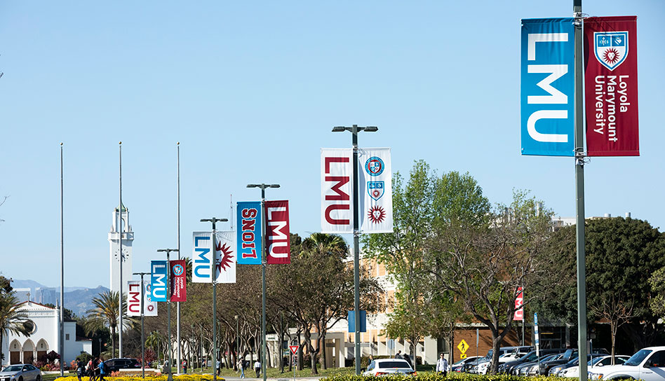 A series of branded light pole banners along the center of the Loyola Blvd entrance
