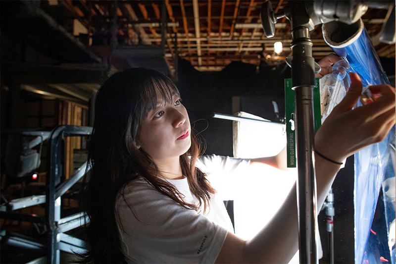 Student working on a film set